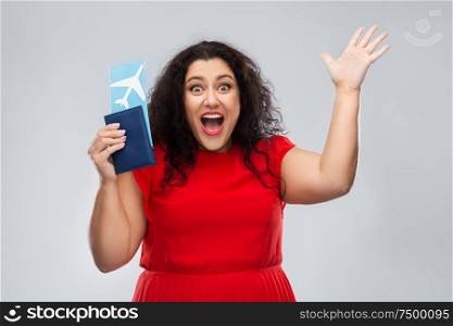 travel, tourism and vacation concept - happy woman in red dress with passport and air ticket over grey background. happy woman with passport and air ticket
