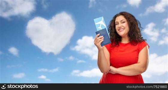 travel, tourism and vacation concept - happy woman in red dress with passport and air ticket over blue sky and cloud in shape of heart background. happy woman with passport and air ticket