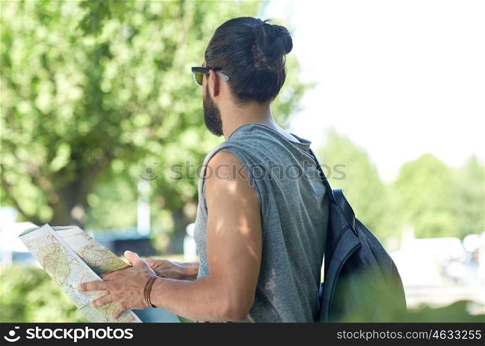 travel, tourism, backpacking and people concept - close up of man traveling with backpack and map in city searching location