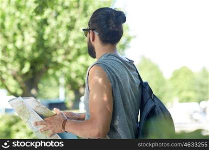 travel, tourism, backpacking and people concept - close up of man traveling with backpack and map in city searching location