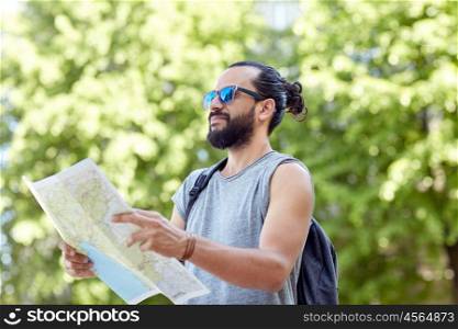 travel, tourism, backpacking and people concept - man traveling with backpack and map in city searching location