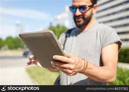 travel, tourism, backpacking, technology and people concept - close up of man with backpack and tablet pc computer in city searching location