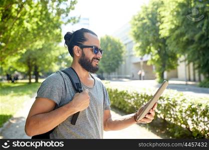 travel, tourism, backpacking, technology and people concept - man traveling with backpack and tablet pc computer in city searching location
