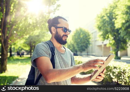 travel, tourism, backpacking, technology and people concept - man traveling with backpack and tablet pc computer in city searching location. man traveling with backpack and tablet pc in city. man traveling with backpack and tablet pc in city