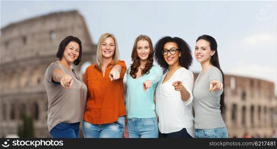 travel, tourism, choice, diverse and people concept - group of happy plus size women in casual clothes pointing finger on you over rome coliseum background