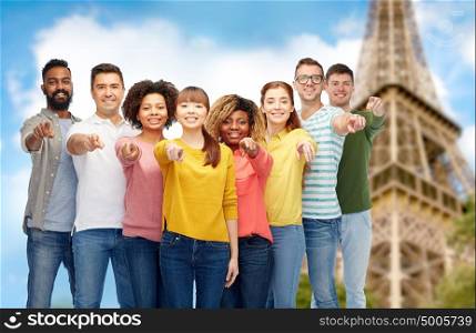travel, tourism, diversity and people concept - international group of happy smiling men and women pointing finger on you over eiffel tower background. international group of people pointing on you