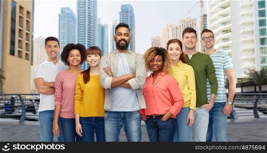 travel, tourism, diversity, ethnicity and people concept - international group of happy smiling men and women over dubai city street background