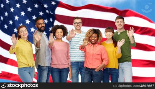 travel, tourism, diversity, ethnicity and people concept - international group of happy smiling men and women waving hand over american flag background