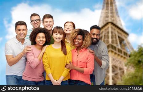 travel, tourism, diversity, friendship and people concept - international group of happy smiling men and women over eiffel tower background. international group of happy smiling people