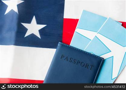 travel, tourism, emigration and visa concept - american national flag, passport and air tickets. american flag, passport and air tickets