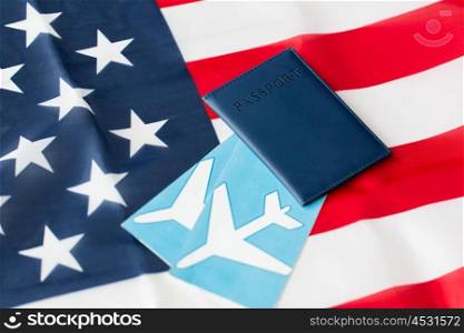 travel, tourism, emigration and visa concept - american national flag, passport and air tickets