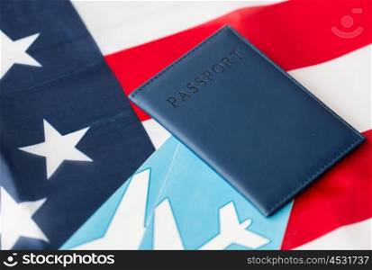 travel, tourism, emigration and visa concept - american national flag, passport and air tickets
