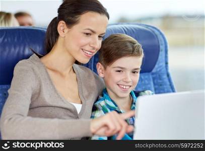 travel, tourism, family, technology and people concept - happy mother and son with tablet pc computer sitting in travel bus or train