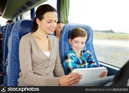 travel, tourism, family, technology and people concept - happy mother and son with tablet pc computer sitting in travel bus