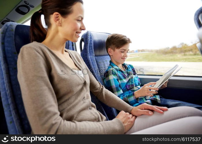 travel, tourism, family, technology and people concept - happy mother and son with tablet pc computer sitting in travel bus