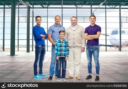 travel, tourism, generation and people concept - group of smiling men and boy over airport terminal background