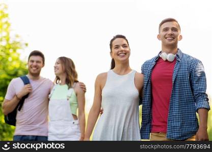 travel, tourism, hike and friendship concept - group of smiling friends with backpack in summer. group of smiling friends with backpack hiking