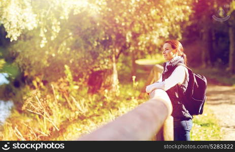 travel, tourism, hike and people concept - happy woman with backpack outdoors. happy woman with backpack outdoors