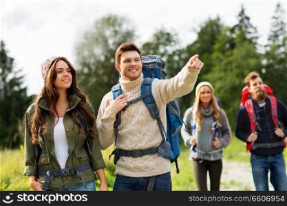 travel, tourism, hiking and people concept - group of happy friends or travelers with backpacks. happy friends or travelers with backpacks hiking