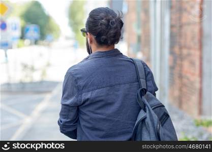 travel, tourism, lifestyle and people concept - close up of man with backpack walking along city street