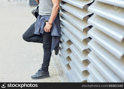 travel, tourism, lifestyle and people concept - close up of man with backpack standing at city street wall