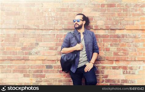 travel, tourism, lifestyle and people concept - happy smiling man with backpack standing at city street wall. happy man with backpack standing at city street. happy man with backpack standing at city street