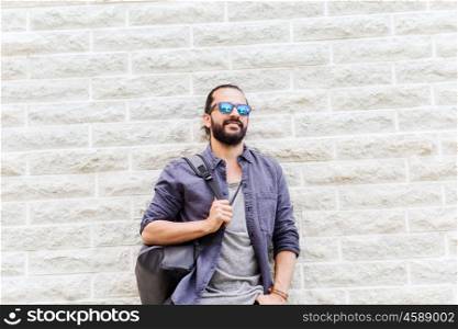 travel, tourism, lifestyle and people concept - man with backpack standing at city street wall. man with backpack standing at city street wall