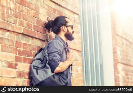 travel, tourism, lifestyle and people concept - man with backpack standing at city street wall. man with backpack standing at city street wall. man with backpack standing at city street wall