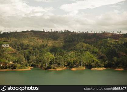 travel, tourism, nature and landscape concept - view to lake or river from land hills on Sri Lanka