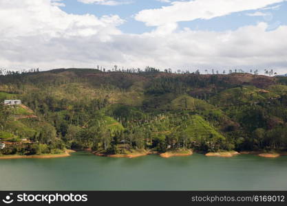 travel, tourism, nature and landscape concept - view to lake or river from land hills on Sri Lanka