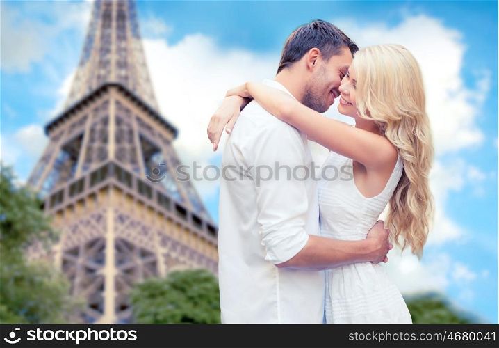 travel, tourism, people, love and dating concept - happy couple hugging over eiffel tower in paris background