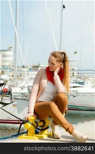 Travel tourism relax and people concept. Fashion attractive woman on pier against white yachts in port