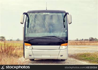 travel, tourism, road trip and passenger transport - tour bus staying outdoors. tour bus staying outdoors