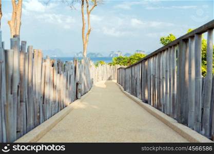 travel, tourism, summer holidays, vacation and leisure concept - road with fence at seaside