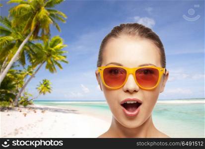travel, tourism, summer holidays, vacation and people concept - amazed young woman or teenage girl in sunglasses over exotic tropical beach background. happy woman or teenage girl in sunglasses on beach. happy woman or teenage girl in sunglasses on beach