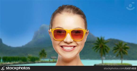 travel, tourism, summer holidays, vacation and people concept - happy young woman or teenage girl in sunglasses over exotic tropical beach background. young woman or teenage girl in sunglasses on beach. young woman or teenage girl in sunglasses on beach
