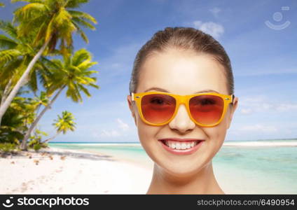 travel, tourism, summer holidays, vacation and people concept - smiling young woman or teenage girl in sunglasses over exotic tropical beach background. happy woman or teenage girl in sunglasses on beach. happy woman or teenage girl in sunglasses on beach