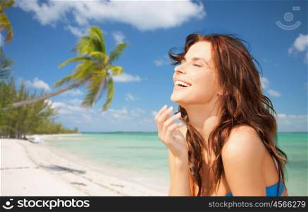 travel, tourism, summer vacation and people concept - happy beautiful woman over tropical beach with sea and palm tree background