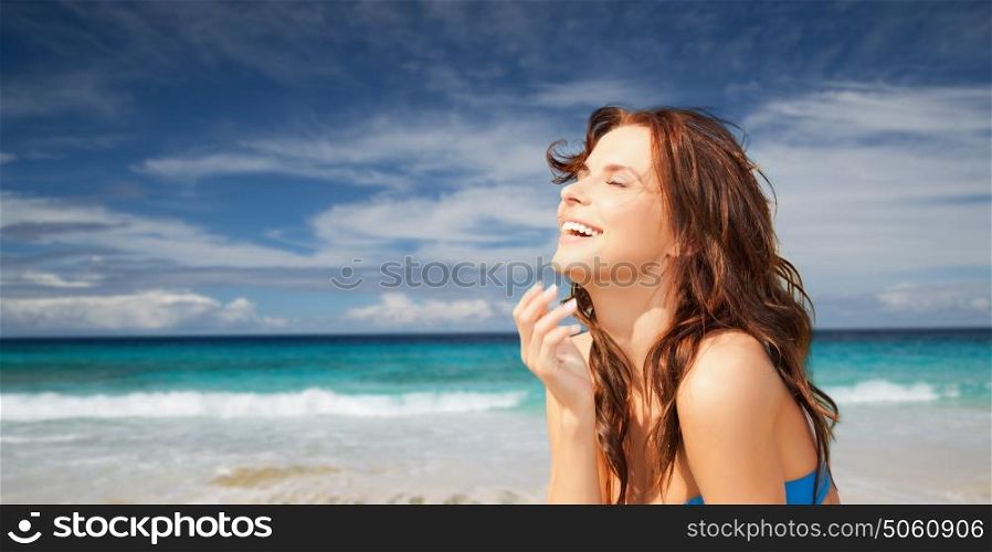 travel, tourism, summer vacation and people concept - happy beautiful woman over exotic tropical beach and ocean background. happy smiling beautiful woman on summer beach