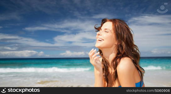 travel, tourism, summer vacation and people concept - happy beautiful woman over exotic tropical beach and ocean background. happy smiling beautiful woman on summer beach