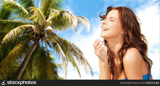 travel, tourism, summer vacation and people concept - happy beautiful woman over exotic tropical beach with palm tree background. happy smiling beautiful woman over summer beach