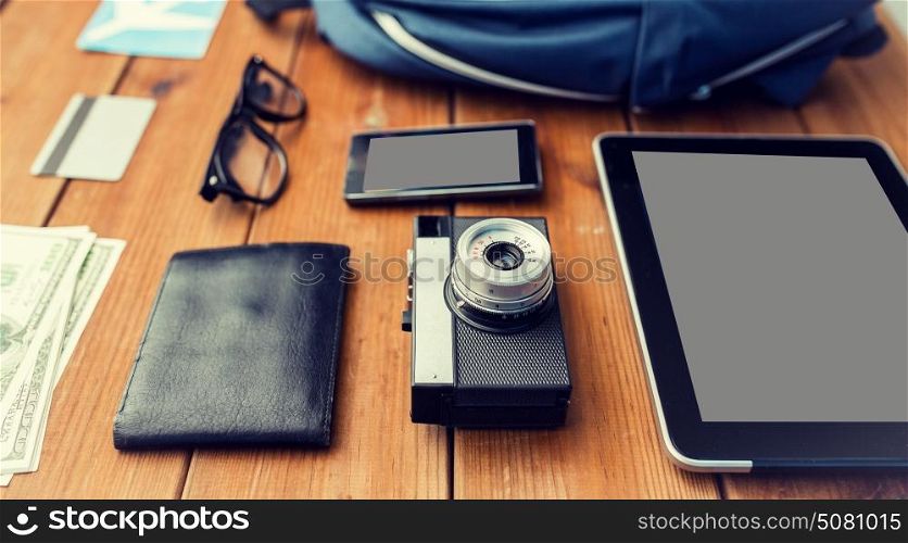 travel, tourism, technology and objects concept - close up of camera, gadgets and personal stuff. close up of camera, gadgets and travel stuff