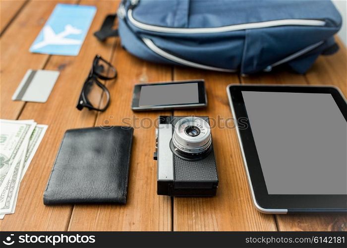 travel, tourism, technology and objects concept - close up of camera, gadgets and personal stuff