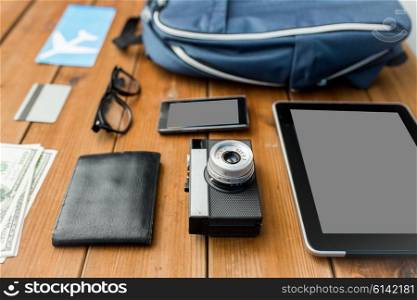 travel, tourism, technology and objects concept - close up of camera, gadgets and personal stuff