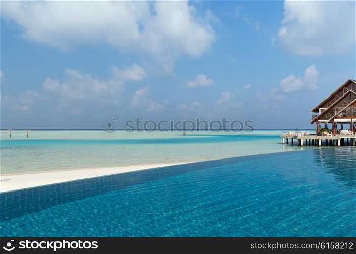 travel, tourism, vacation and summer holidays concept - access to patio or terrace with canopy on maldives beach sea shore
