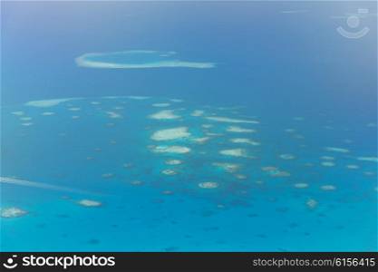 travel, tourism, vacation and summer holidays concept - Maldive island in ocean
