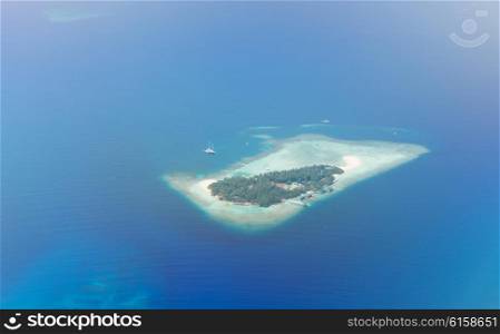 travel, tourism, vacation and summer holidays concept - Maldive island in ocean