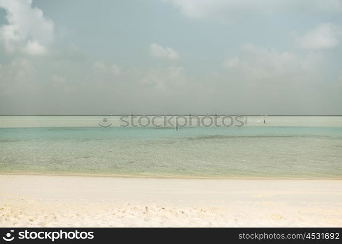 travel, tourism, vacation and summer holidays concept - sea and sky on maldives beach