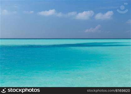 travel, tourism, vacation and summer holidays concept - sea and sky on maldives beach
