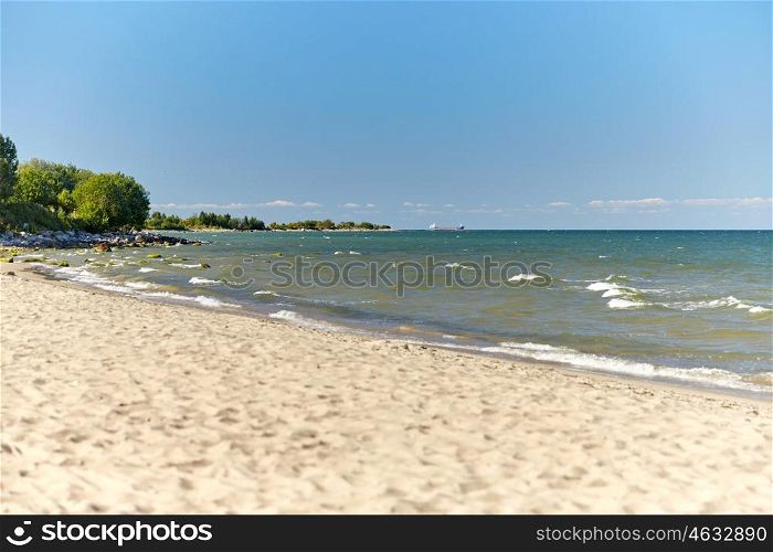 travel, tourism, vacation, seascape and summer holidays concept - baltic sea beach